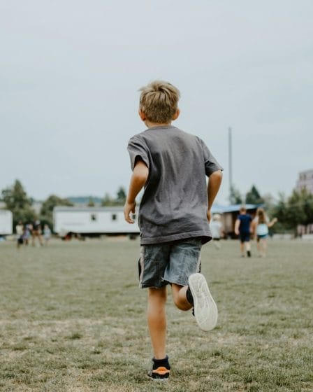 boy running on lawn